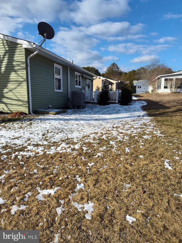 view of snowy exterior with central air condition unit