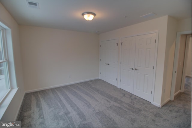 unfurnished bedroom with light colored carpet