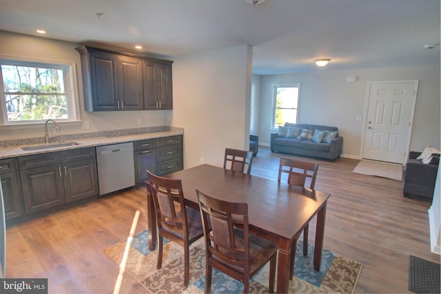 dining space featuring sink and light wood-type flooring