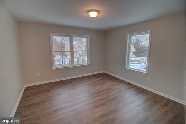 spare room featuring dark hardwood / wood-style flooring