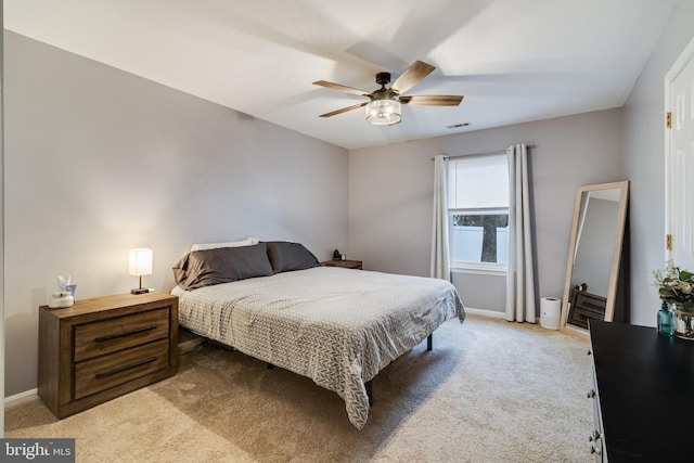 bedroom with ceiling fan and light colored carpet