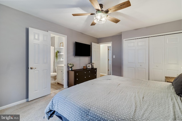 bedroom with light colored carpet, a closet, ceiling fan, and ensuite bathroom