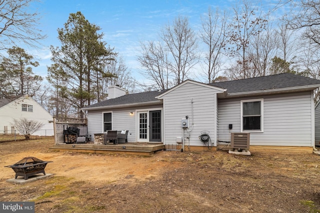 back of house with a deck, central air condition unit, and an outdoor fire pit