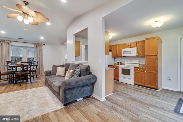 living room with ceiling fan and light hardwood / wood-style flooring