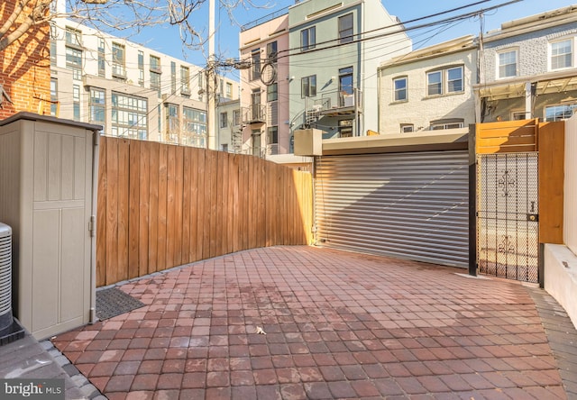 view of gate featuring a patio area