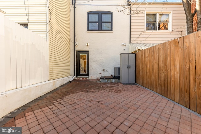 rear view of property featuring central AC and a patio