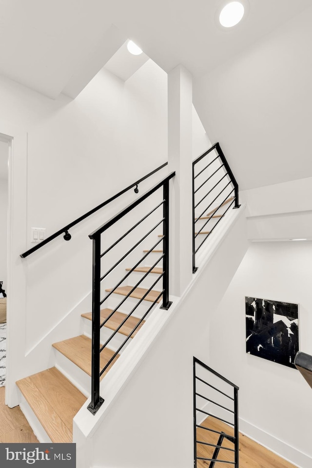 stairway with hardwood / wood-style flooring