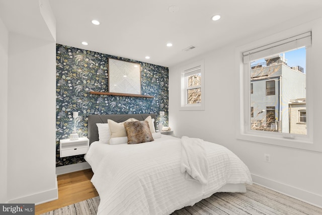 bedroom featuring multiple windows and light wood-type flooring