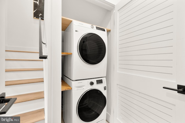 laundry room with stacked washing maching and dryer