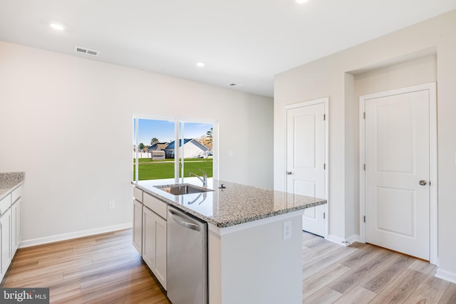 kitchen featuring white cabinetry, sink, dishwasher, and an island with sink