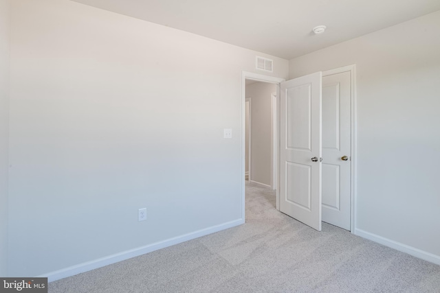 unfurnished bedroom with light colored carpet