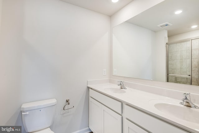 bathroom featuring walk in shower, vanity, and toilet