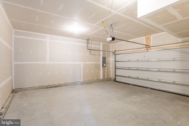 garage featuring a garage door opener and electric panel