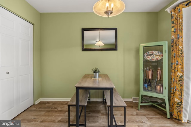 dining room with wood-type flooring