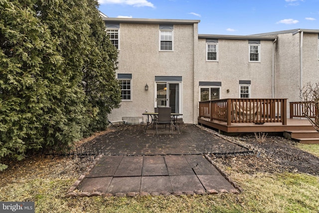 back of house with a deck and a patio area