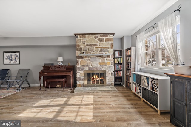 sitting room featuring a fireplace and light hardwood / wood-style flooring