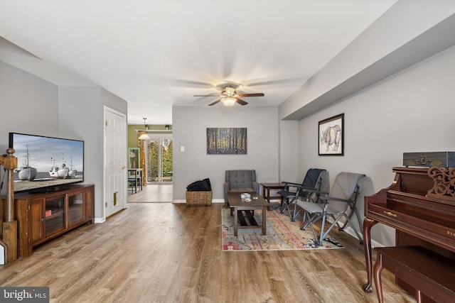 living room featuring ceiling fan and light wood-type flooring