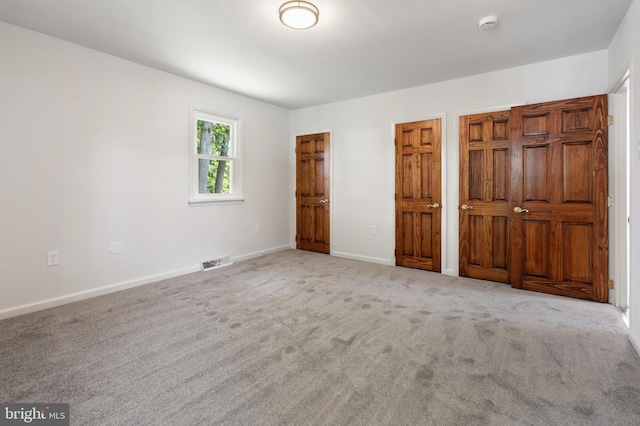 unfurnished bedroom with light carpet