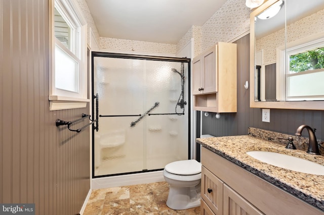 bathroom with vanity, toilet, and walk in shower