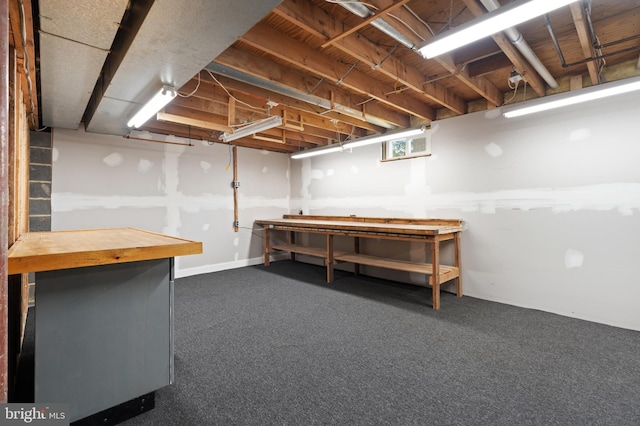 basement with dark colored carpet