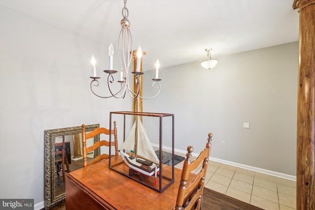 dining area with a chandelier and tile patterned flooring