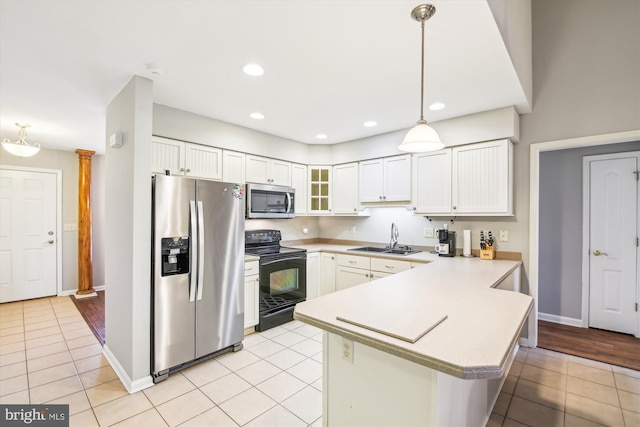 kitchen with sink, white cabinetry, light tile patterned floors, appliances with stainless steel finishes, and kitchen peninsula