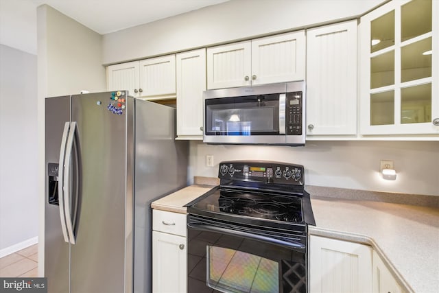 kitchen featuring white cabinetry, appliances with stainless steel finishes, and light tile patterned floors