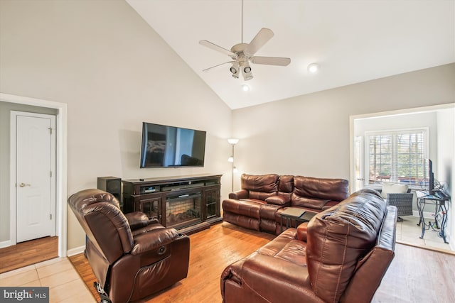 living room with high vaulted ceiling, light hardwood / wood-style floors, and ceiling fan