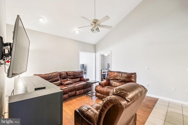 living room with high vaulted ceiling, light tile patterned floors, and ceiling fan