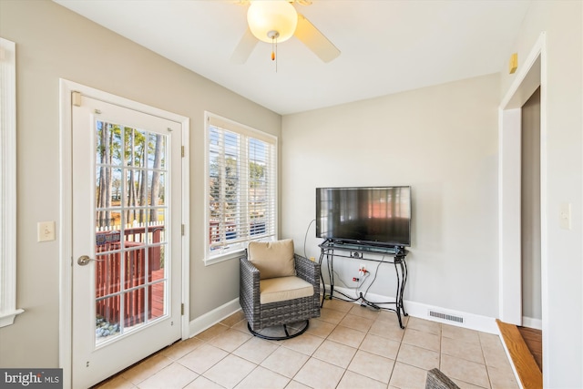 sitting room featuring ceiling fan and light tile patterned floors