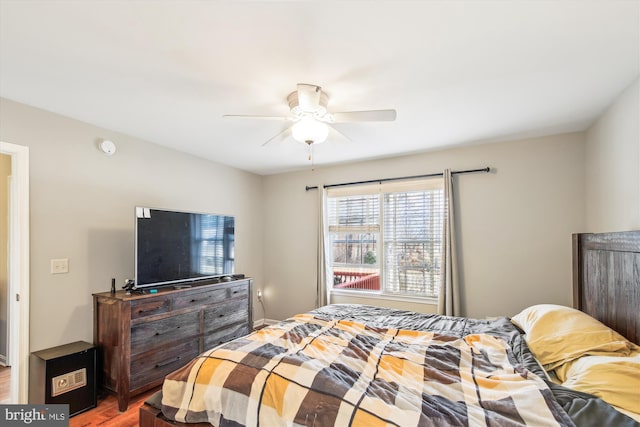 bedroom with wood-type flooring and ceiling fan