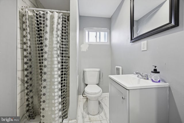 bathroom featuring vanity, walk in shower, and toilet