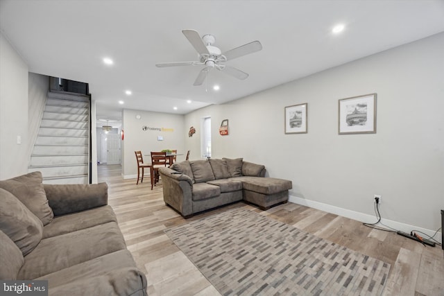 living room with ceiling fan and light wood-type flooring