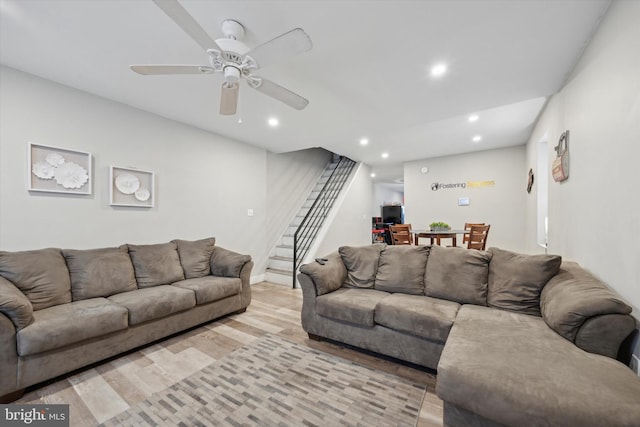 living room featuring ceiling fan and light wood-type flooring