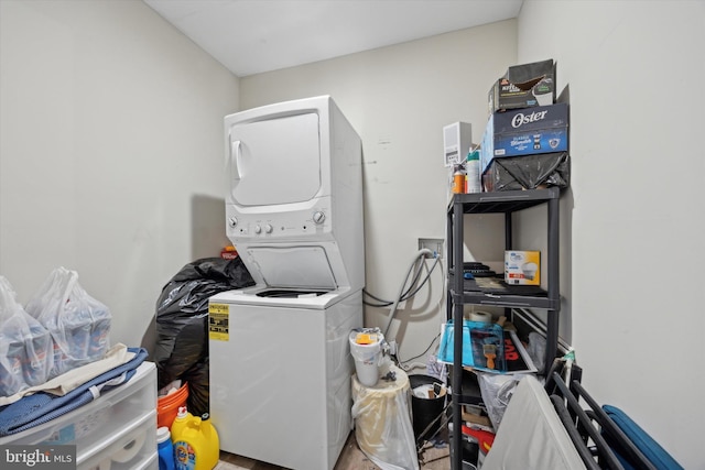 clothes washing area featuring stacked washer and clothes dryer