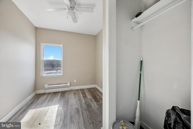 interior space featuring light hardwood / wood-style flooring, ceiling fan, and baseboard heating