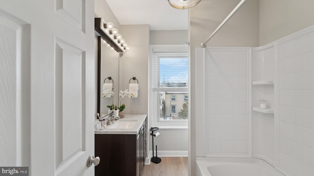 bathroom featuring vanity, tub / shower combination, and wood-type flooring