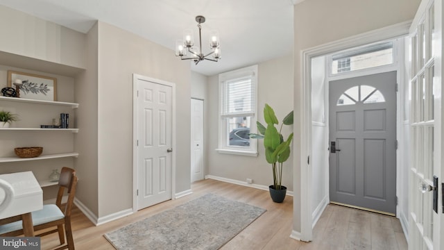 entryway featuring a chandelier and light wood-type flooring