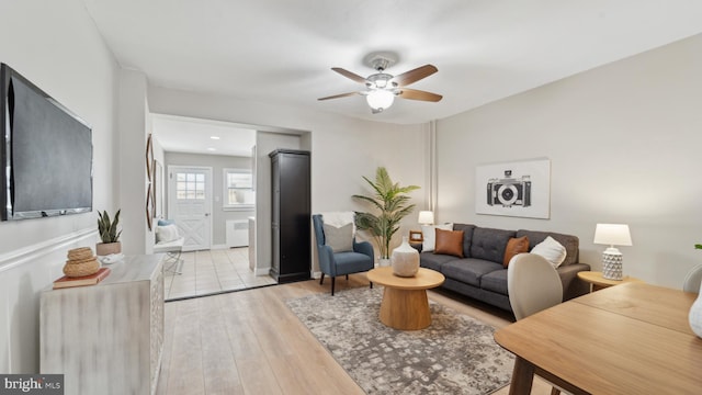 living room featuring light hardwood / wood-style floors and ceiling fan