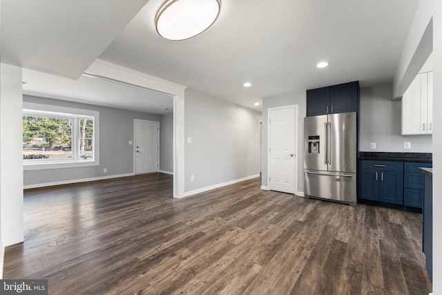 kitchen featuring blue cabinetry, white cabinetry, high quality fridge, and dark hardwood / wood-style floors