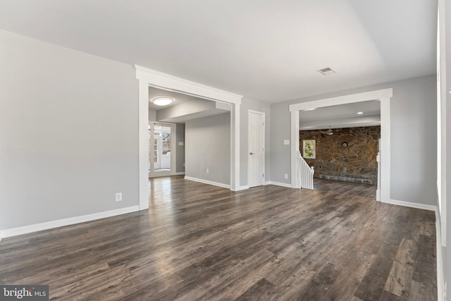 unfurnished living room with dark hardwood / wood-style floors