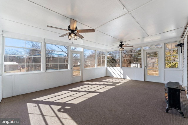 unfurnished sunroom with ceiling fan