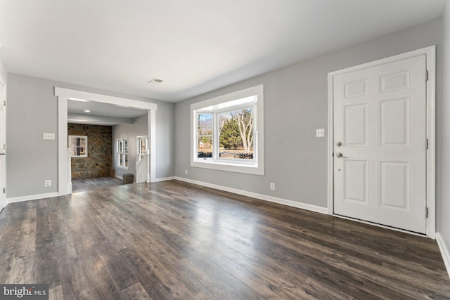 unfurnished living room featuring dark hardwood / wood-style flooring