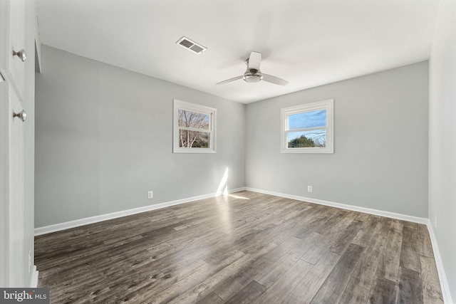 spare room with ceiling fan and dark hardwood / wood-style flooring