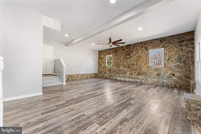 unfurnished living room with beam ceiling, ceiling fan, and hardwood / wood-style flooring