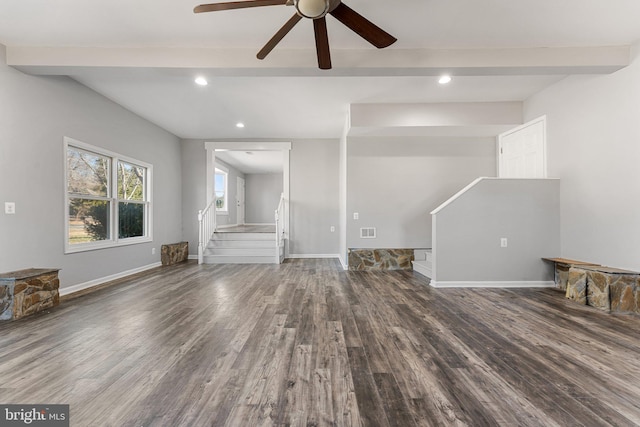 unfurnished living room with dark wood-type flooring and beam ceiling