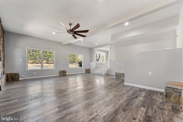 unfurnished living room with dark hardwood / wood-style flooring, ceiling fan, and beam ceiling