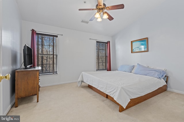 bedroom featuring light carpet, vaulted ceiling, and ceiling fan