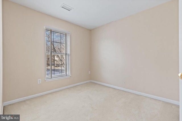 unfurnished room with light carpet