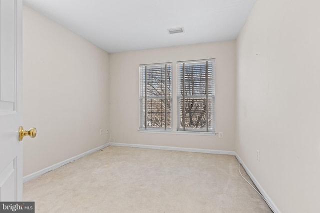 spare room with light colored carpet